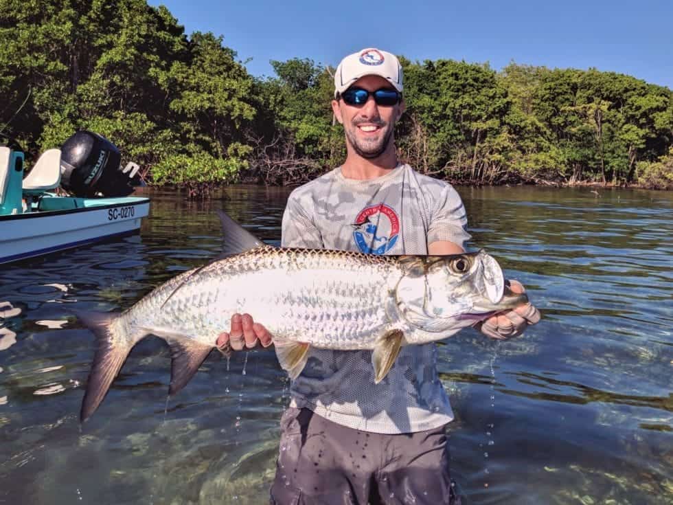 Central America Fishing owner, Chris, releases a tarpon in Belize