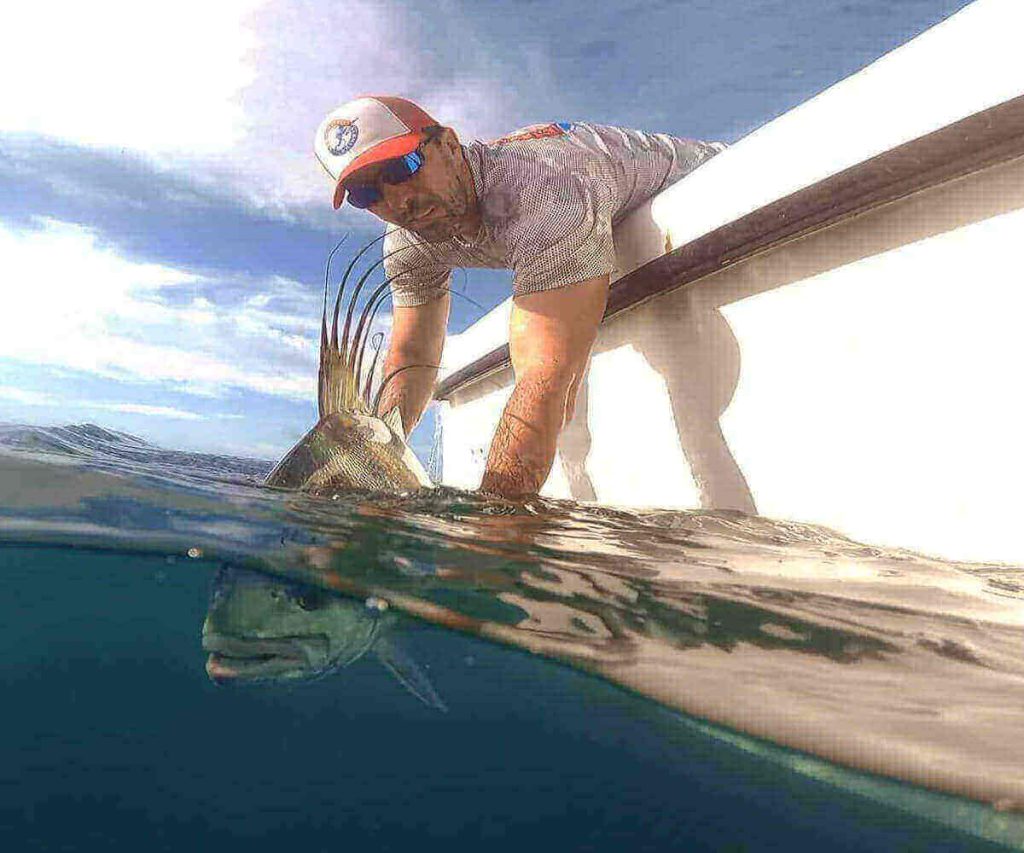 CAF owner, Chris Atkins, releasing a roosterfish back into the water.