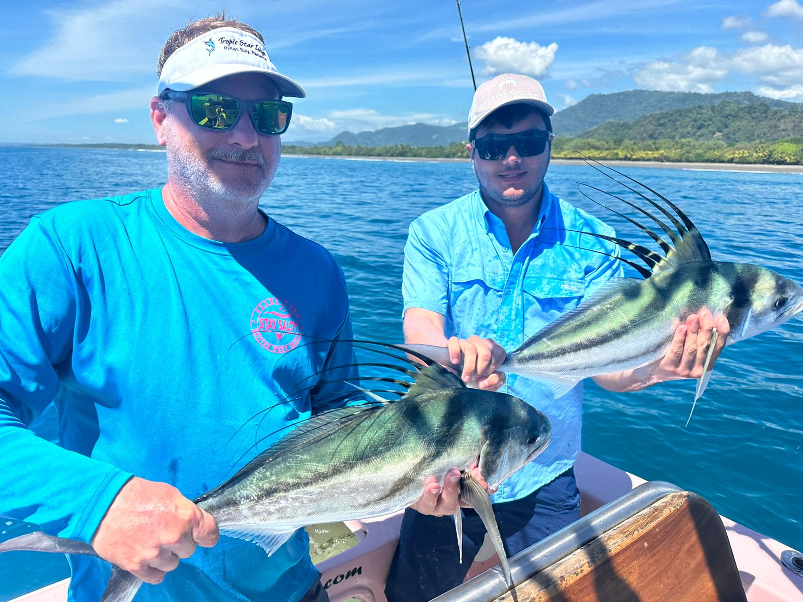 CAF repeat clients, the Johnson family, with two of their record 26 roosterfish caught in a single day in Quepos